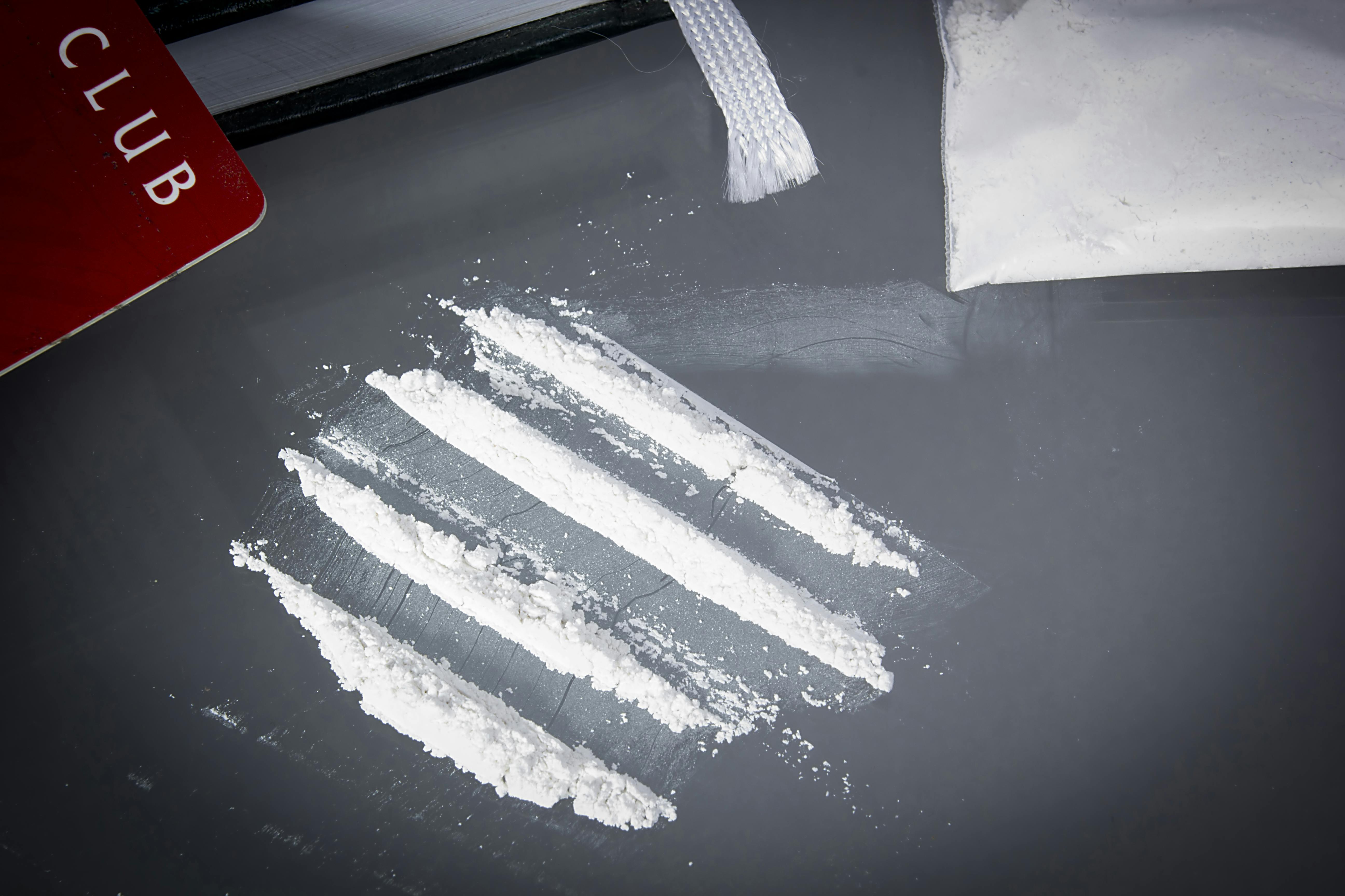 Drug cocaine in a bag and poured on a table