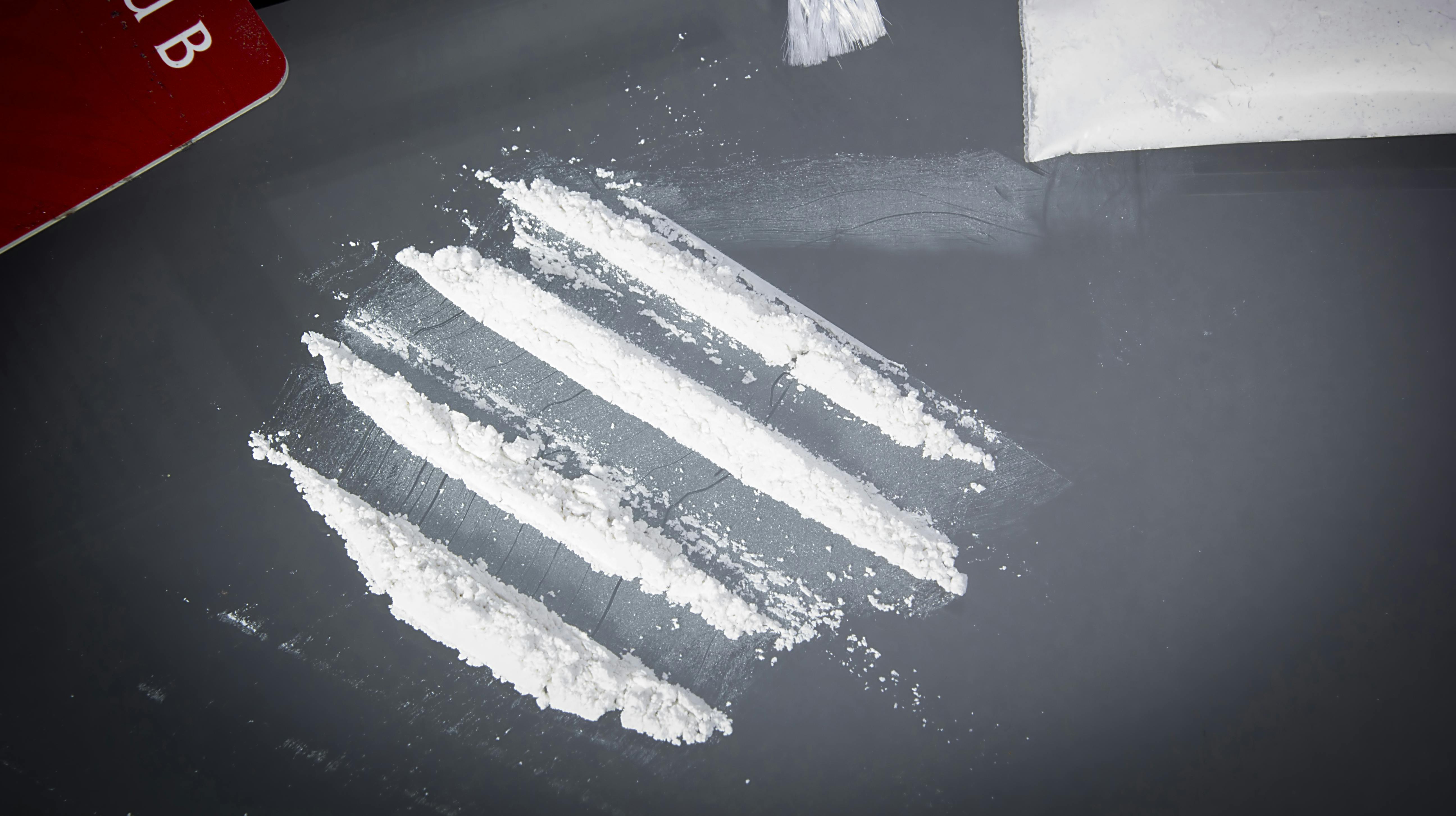 Drug cocaine in a bag and poured on a table