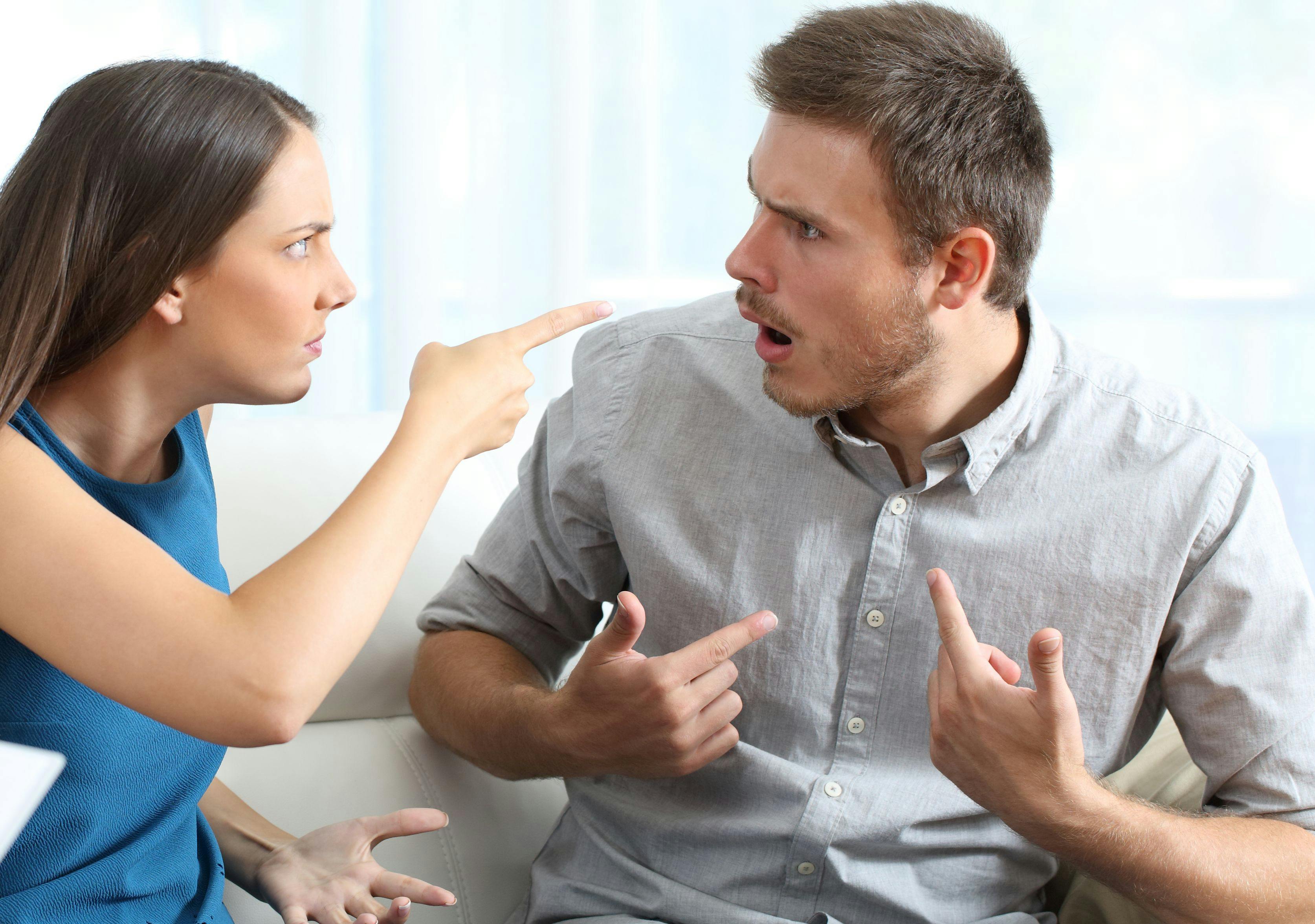 Marriage accusing during a couple therapy sitting on a couch at home or consultation