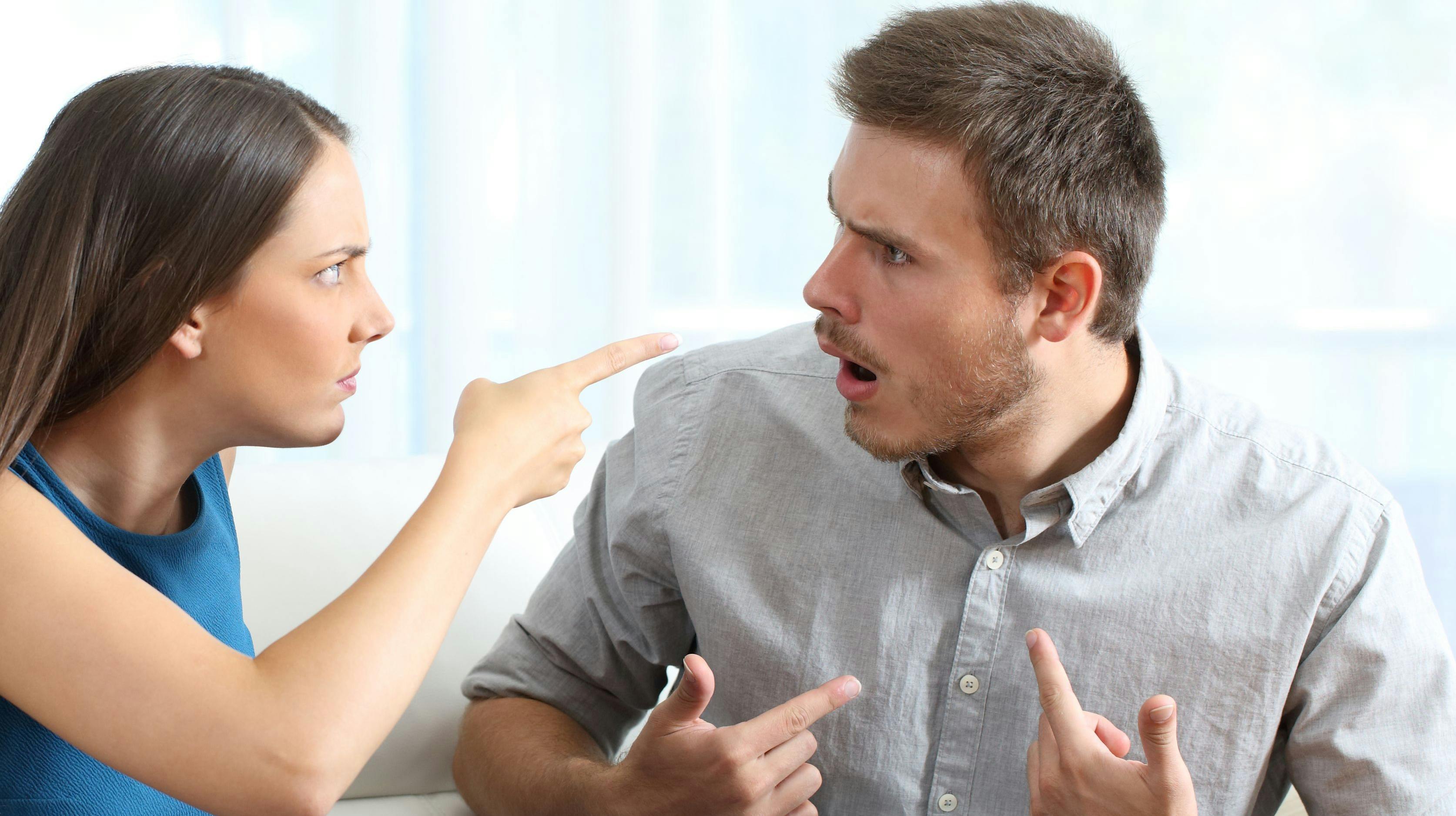 Marriage accusing during a couple therapy sitting on a couch at home or consultation