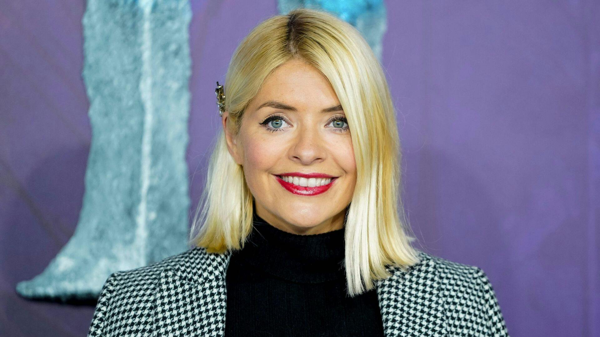 British model and television presenter Holly Willoughby poses on the red carpet as she arrives to attend the European premiere of the film "Frozen 2" in London on November 17, 2019. (Photo by Niklas HALLE'N / AFP)