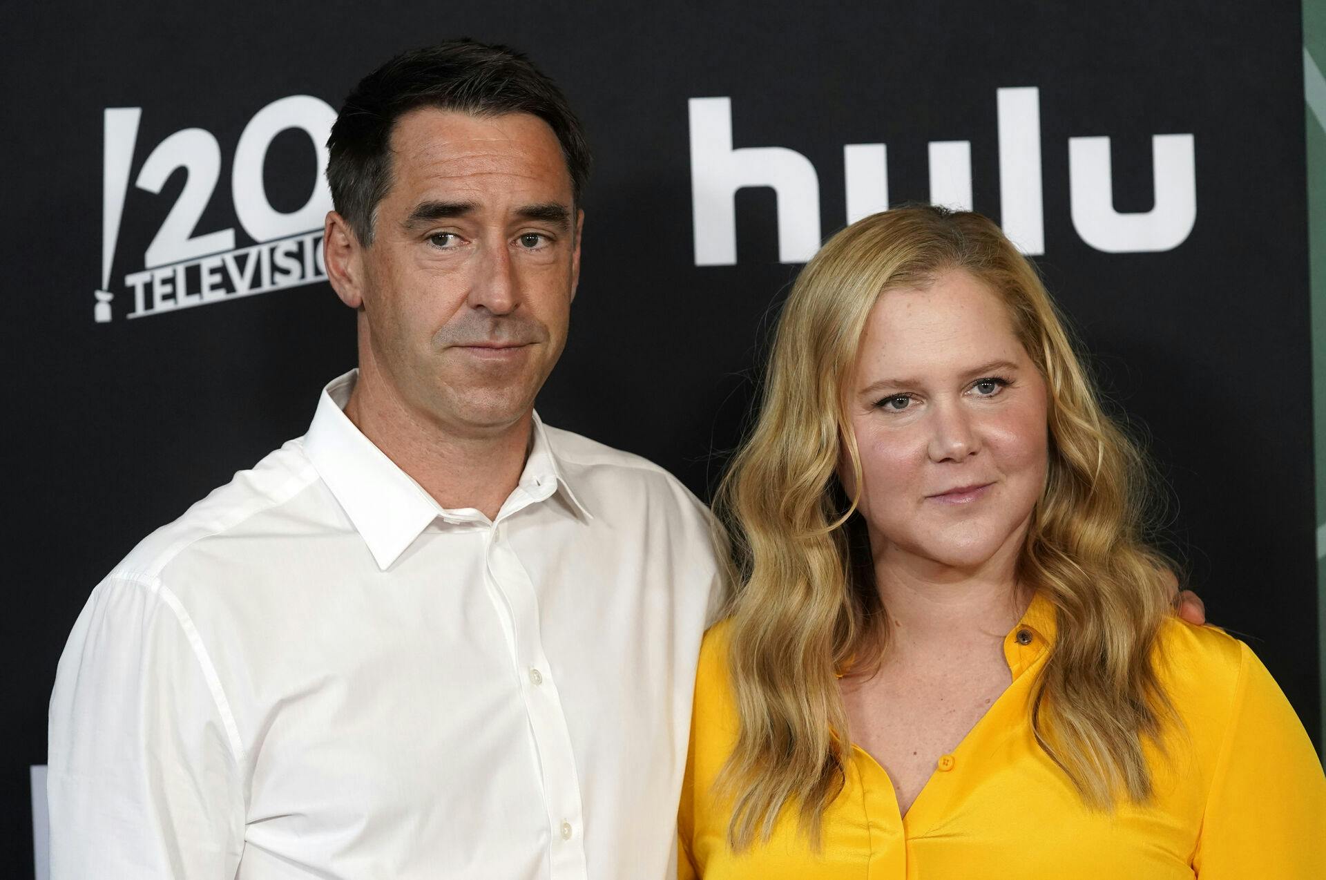 Amy Schumer poses with her husband Chris Fischer at the second season premiere of the Hulu series "Only Murders in the Building, " Monday, June 27, 2022, at the Directors Guild of America in Los Angeles. (AP Photo/Chris Pizzello)