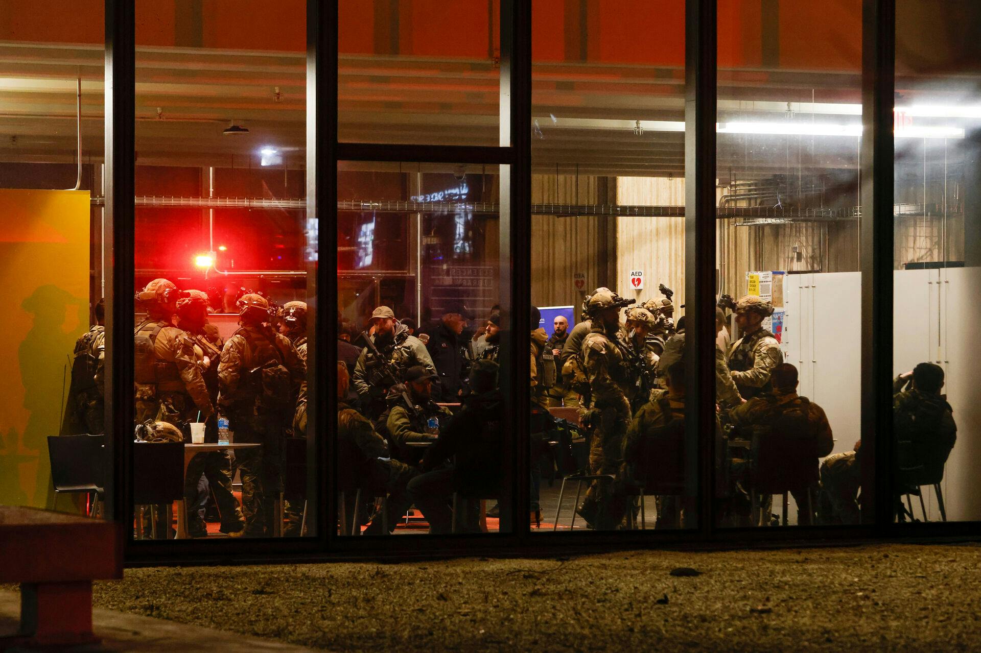 Police S.W.A.T. team members gather inside Brown University's Sciences Library after a shooting Saturday, Dec. 13, 2025, in Providence, R.I. (Lily Speredelozzi/The Sun Chronicle via AP)