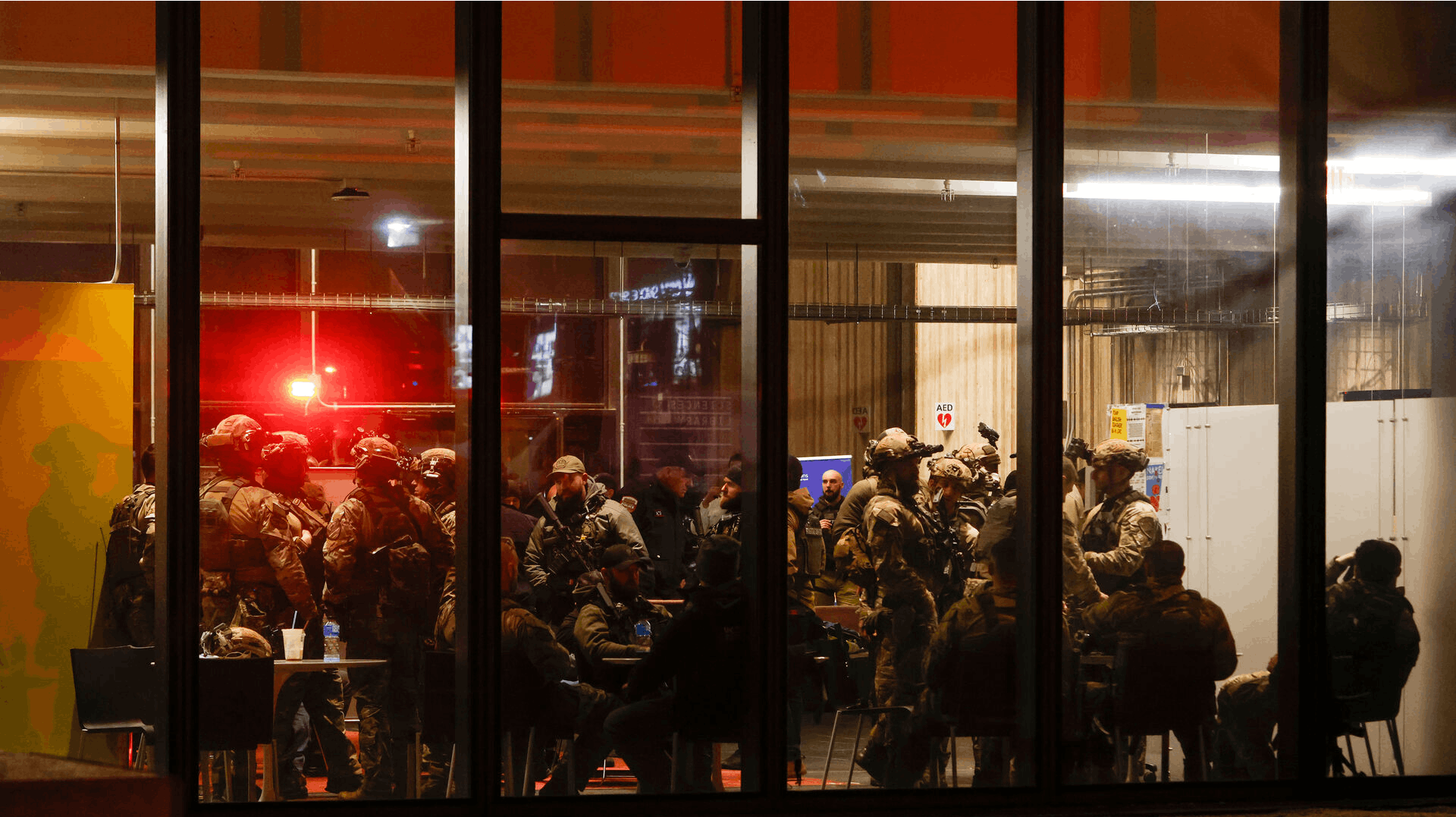 Police S.W.A.T. team members gather inside Brown University's Sciences Library after a shooting Saturday, Dec. 13, 2025, in Providence, R.I. (Lily Speredelozzi/The Sun Chronicle via AP)