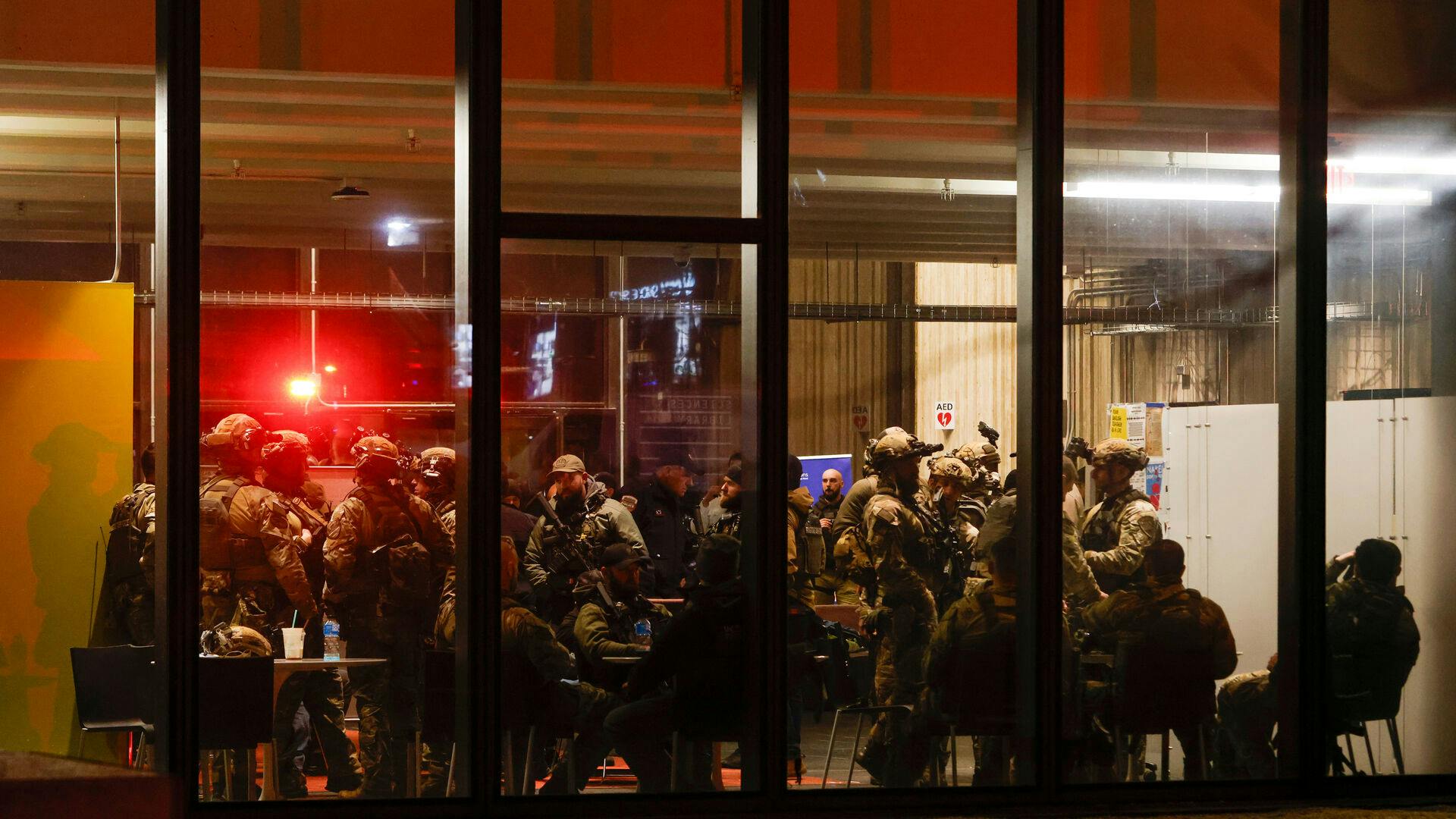 Police S.W.A.T. team members gather inside Brown University's Sciences Library after a shooting Saturday, Dec. 13, 2025, in Providence, R.I. (Lily Speredelozzi/The Sun Chronicle via AP)