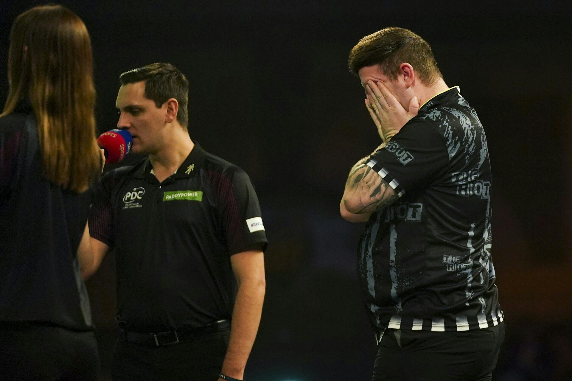 Callan Rydz of England, right, celebrates his victory in the round 4 match against Rob Owen of Wales at the World Darts Championship in London, Monday, Dec. 30, 2024. (AP Photo/Alberto Pezzali)