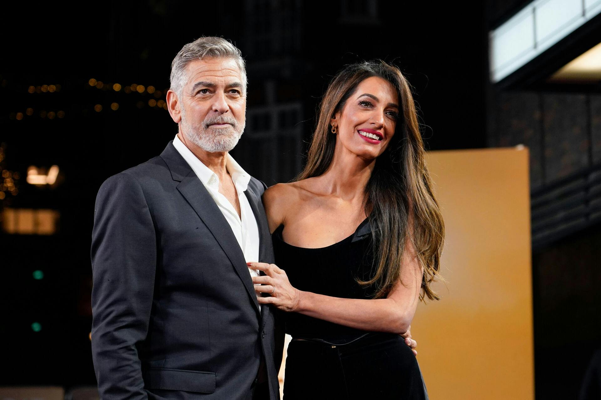 FILE - George Clooney and his wife Amal Clooney pose for photographers upon arrival at the screening of the film "The Boys In The Boat, " Dec. 3, 2023, in London. (Photo by Alberto Pezzali/Invision/AP, File)
