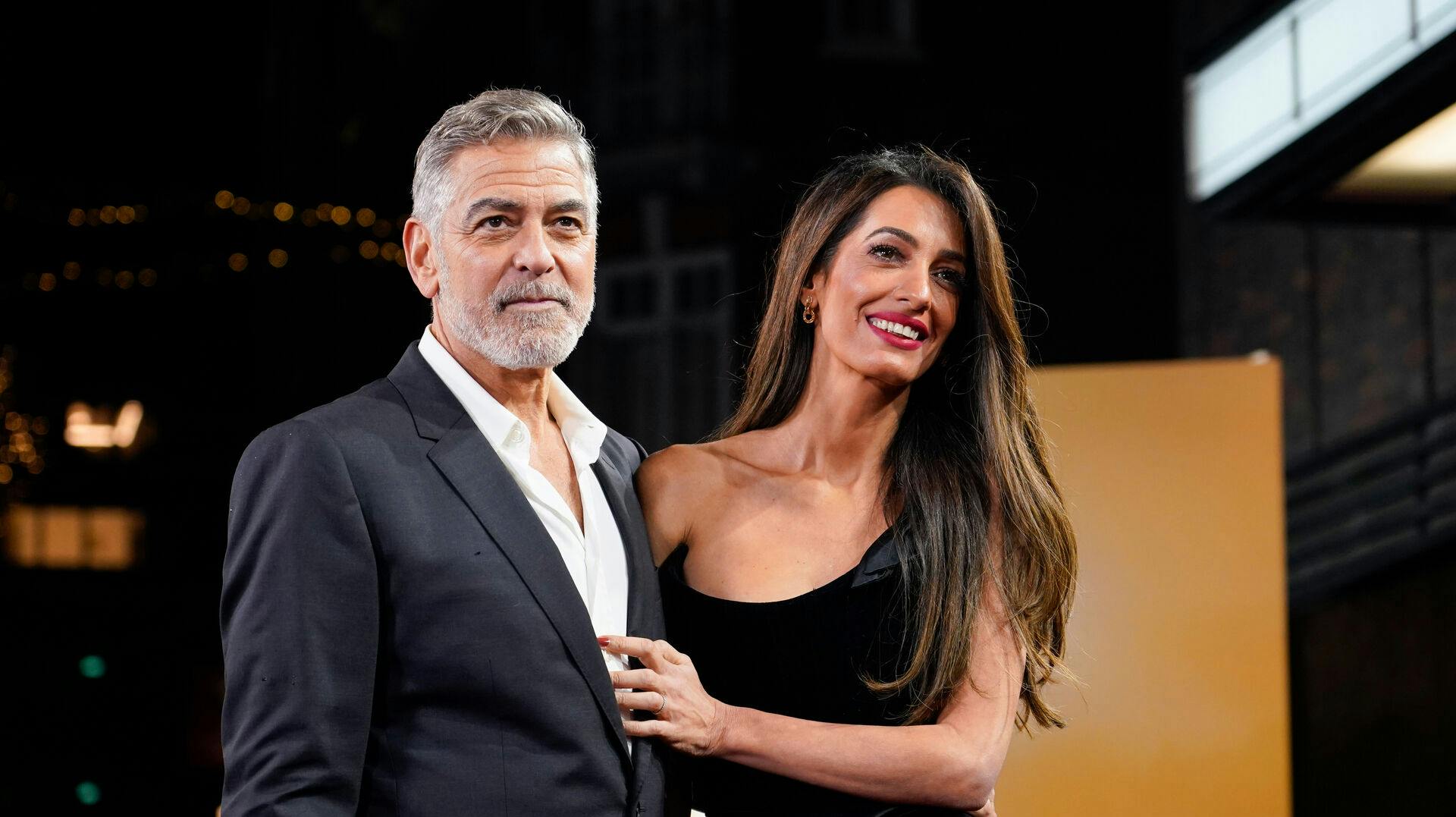 FILE - George Clooney and his wife Amal Clooney pose for photographers upon arrival at the screening of the film "The Boys In The Boat, " Dec. 3, 2023, in London. (Photo by Alberto Pezzali/Invision/AP, File)