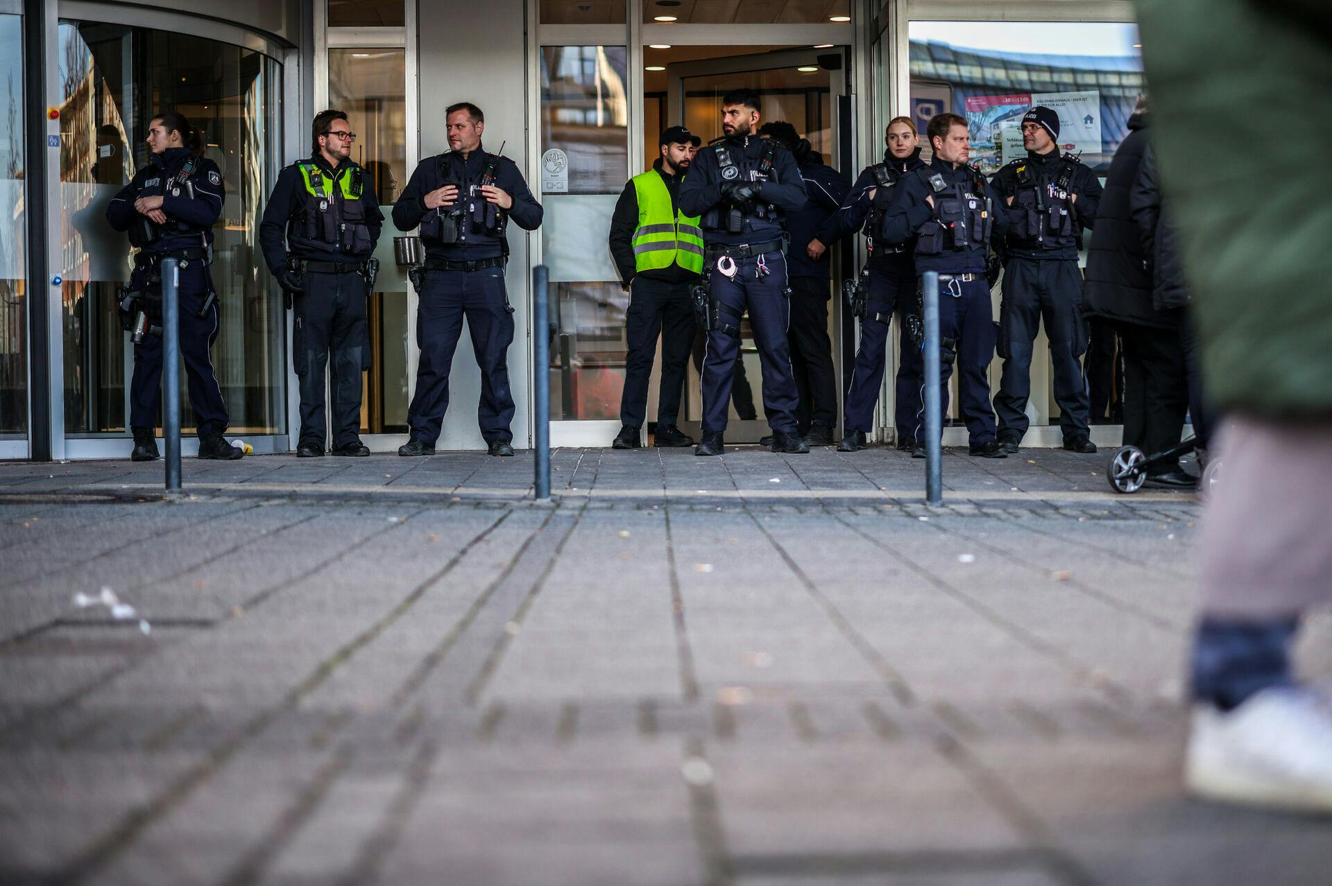 Police officers stand in front of the savings bank branch in the Buer district in Gelsenkirchen, Germany, Tuesday, Dec. 30, 2025 following a break-in into the bank's vault. (Christoph Reichwein/dpa via AP)