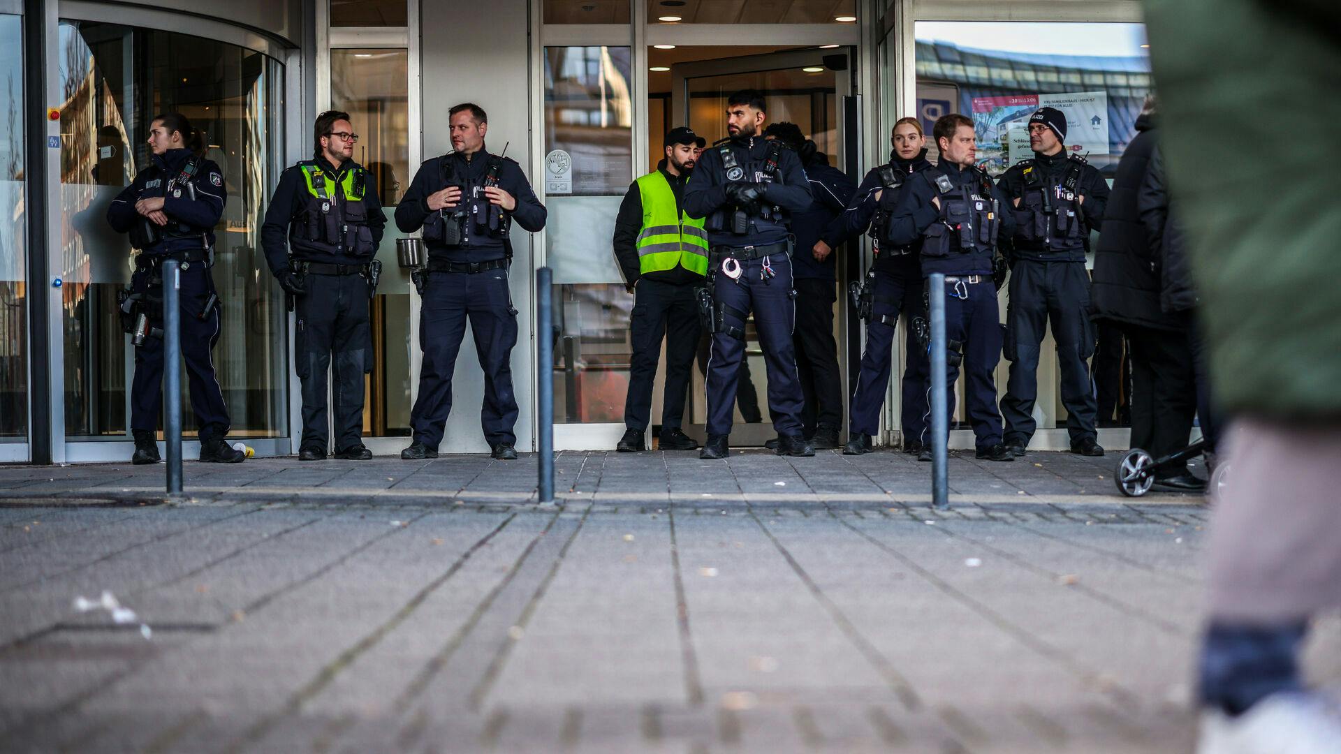 Police officers stand in front of the savings bank branch in the Buer district in Gelsenkirchen, Germany, Tuesday, Dec. 30, 2025 following a break-in into the bank's vault. (Christoph Reichwein/dpa via AP)
