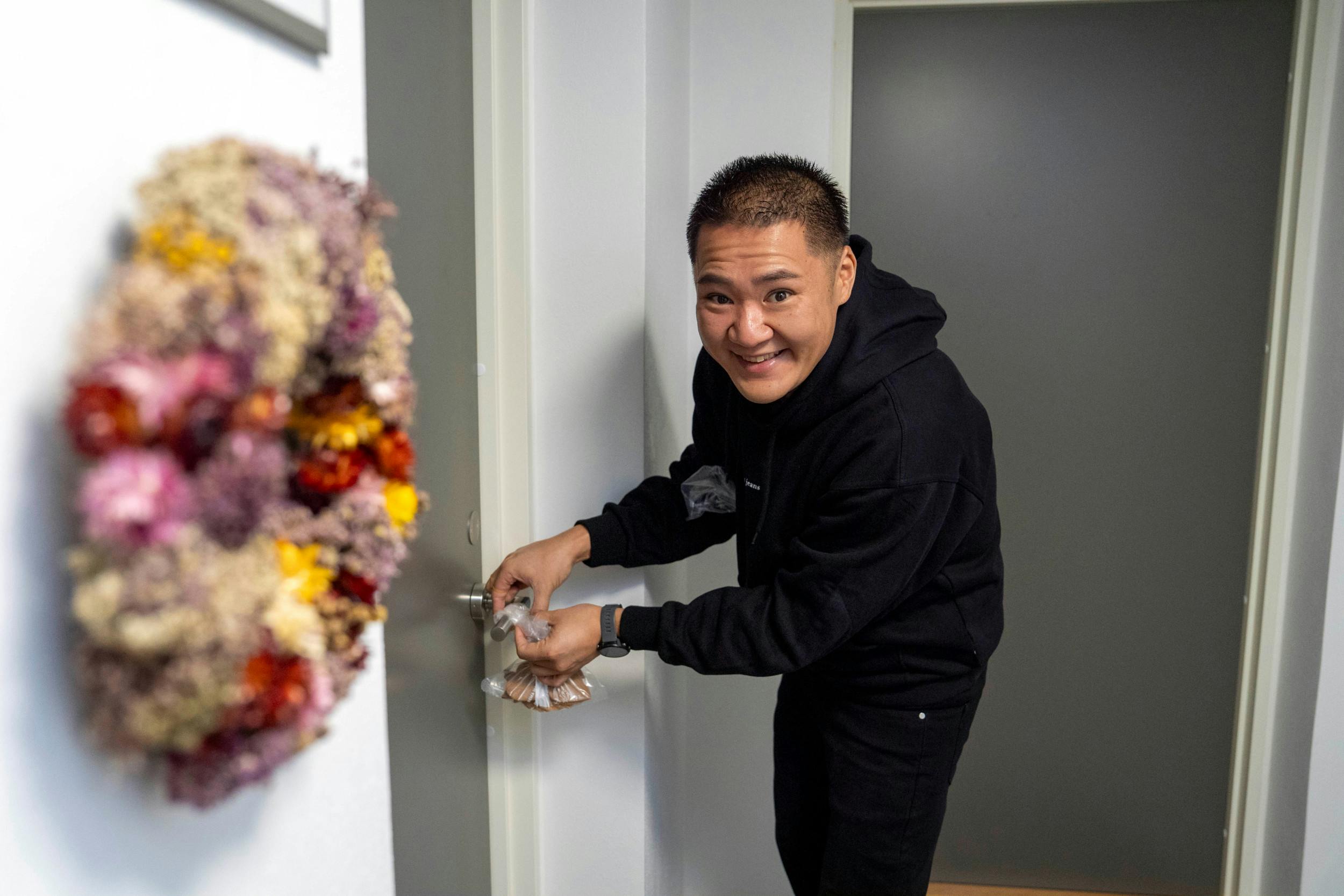 Cheng må være den mest populære mand i lejlighedskomplekset i Randers, for han hænger julebag på naboernes døre.