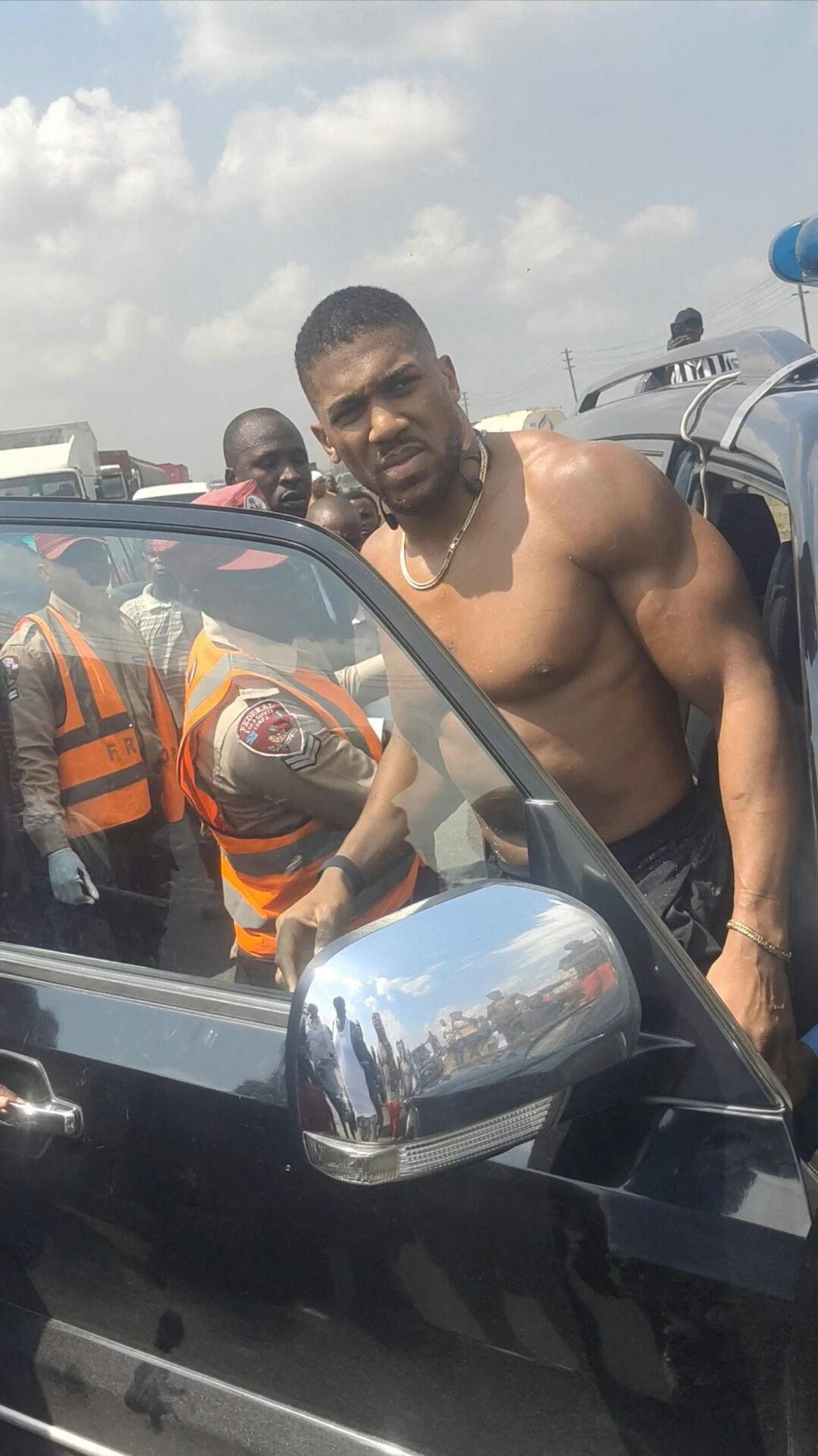 Former heavyweight boxing champion Anthony Joshua looks on as he gets on a vehicle following a car accident, near Sagamu, Ogun State, Nigeria December 29, 2025, in this picture obtained from social media. Sodiq Ayo/via REUTERS THIS IMAGE HAS BEEN SUPPLIED BY A THIRD PARTY. MANDATORY CREDIT.NO RESALES.NO ARCHIVES.