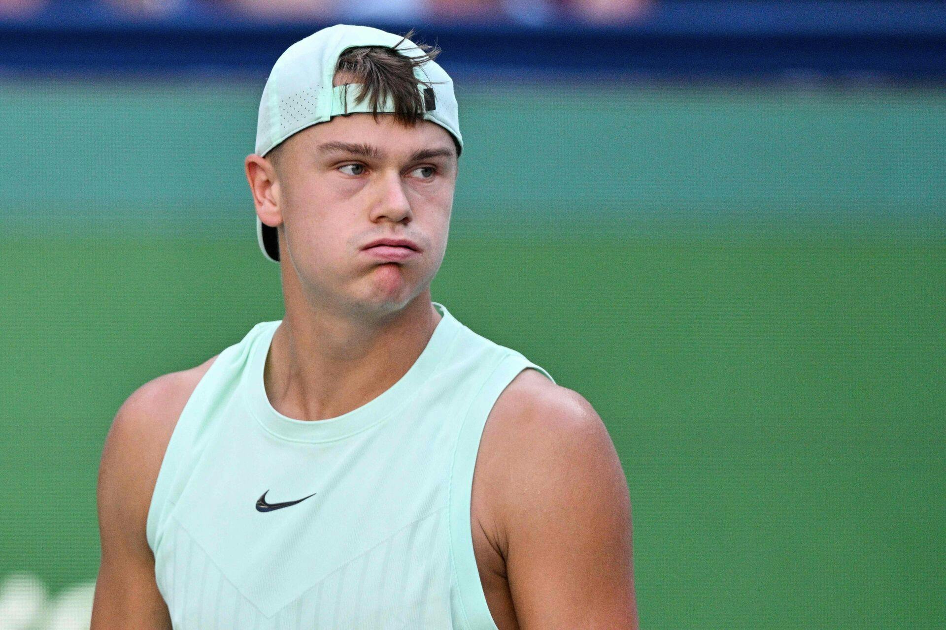 Denmark's Holger Rune reacts while playing against Monaco's Valentin Vacherot in their men's singles quarter-final match at the Shanghai Masters tennis tournament in Shanghai on October 9, 2025. (Photo by Hector RETAMAL / AFP)