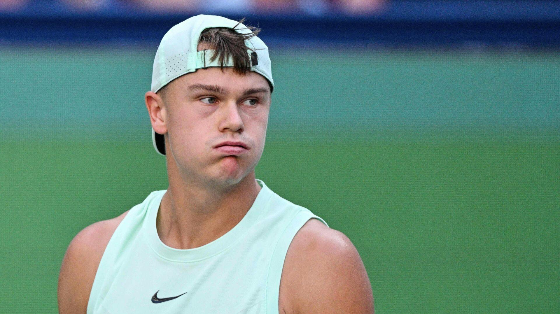 Denmark's Holger Rune reacts while playing against Monaco's Valentin Vacherot in their men's singles quarter-final match at the Shanghai Masters tennis tournament in Shanghai on October 9, 2025. (Photo by Hector RETAMAL / AFP)