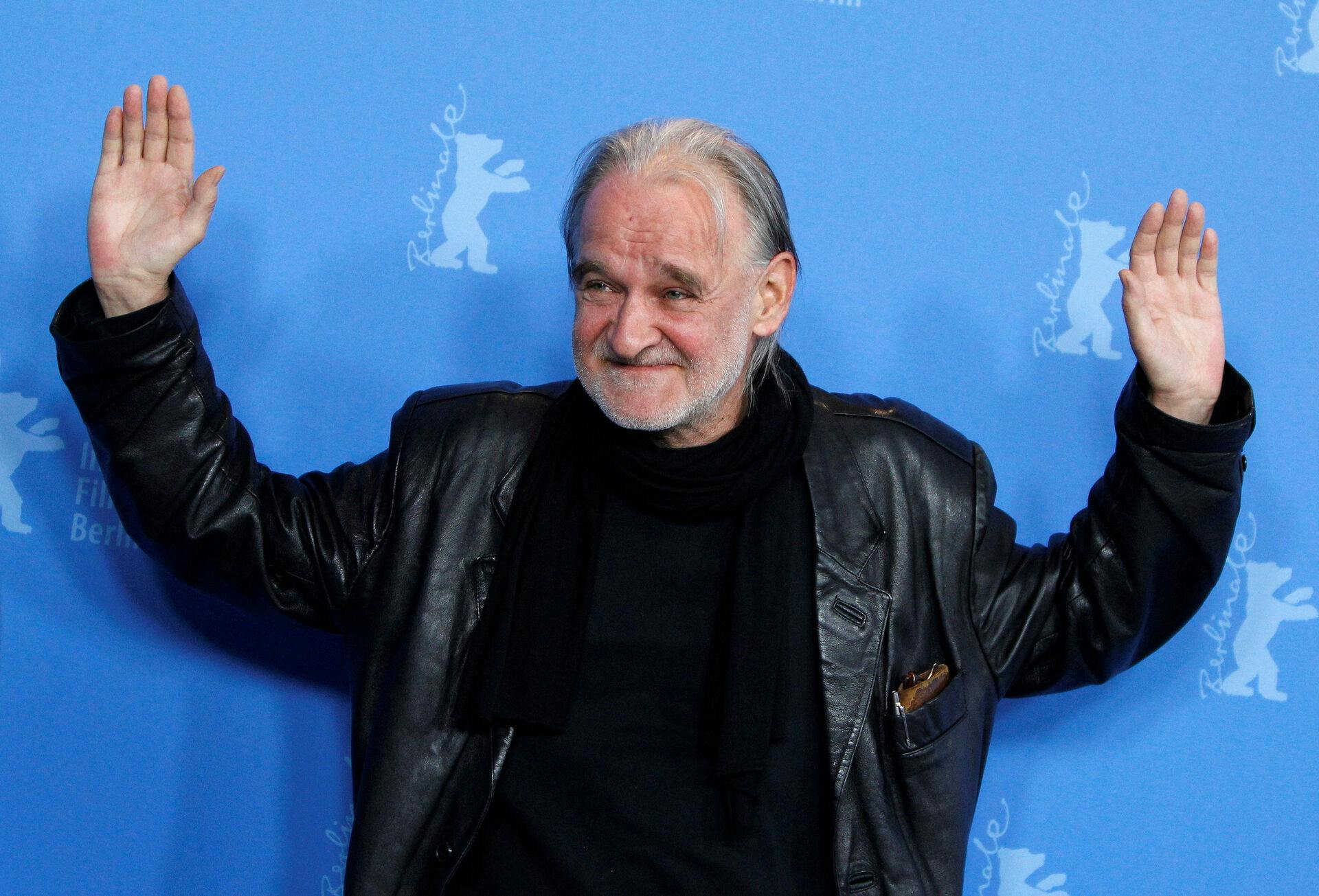 FILE PHOTO: Hungarian director Bela Tarr poses during a photocall for his movie 'A Torinoi Lo' (The Turin Horse) at the 61st Berlinale International Film Festival in Berlin February 15, 2011. REUTERS/Christian Charisius/File Photo