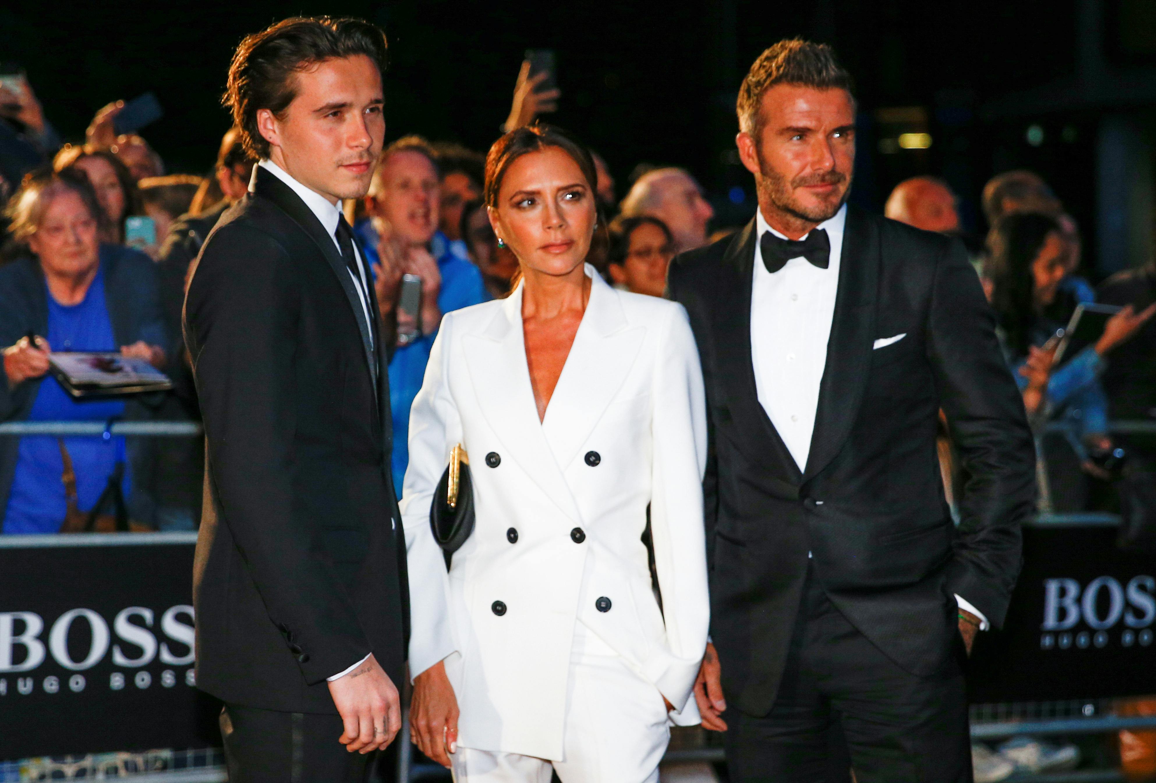 David Beckham, his wife Victoria Beckham and one of their sons, Brooklyn Beckham arrive to the GQ Men Of The Year Awards 2019 in London, Britain September 3, 2019. REUTERS/Henry Nicholls