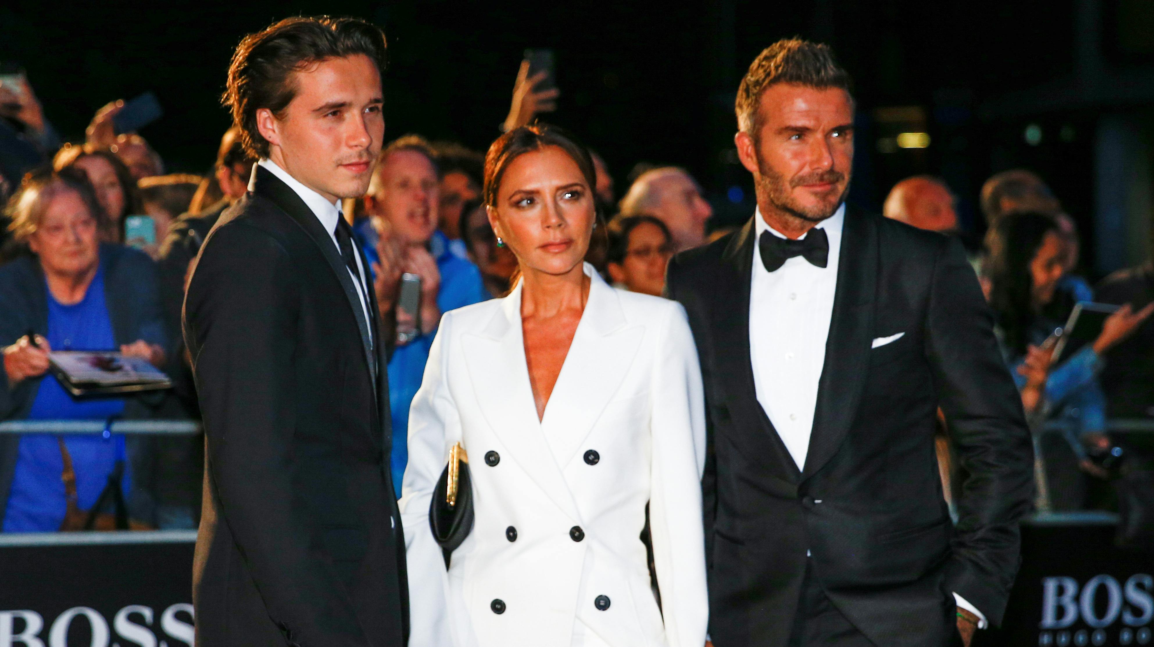David Beckham, his wife Victoria Beckham and one of their sons, Brooklyn Beckham arrive to the GQ Men Of The Year Awards 2019 in London, Britain September 3, 2019. REUTERS/Henry Nicholls