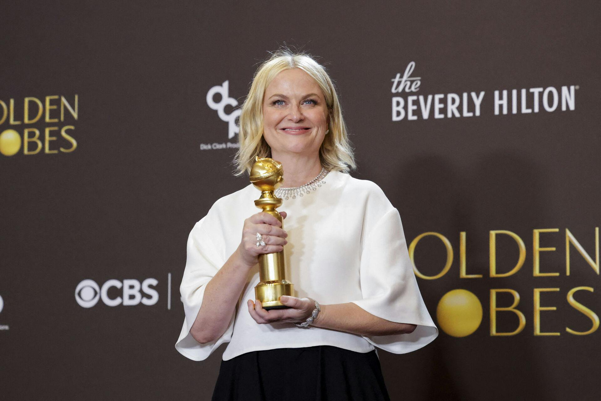 Amy Poehler poses with the Best Podcast award for "Good Hang with Amy Poehler" at the 83rd Annual Golden Globes in Beverly Hills, California, U.S., January 11, 2026. REUTERS/Mario Anzuoni