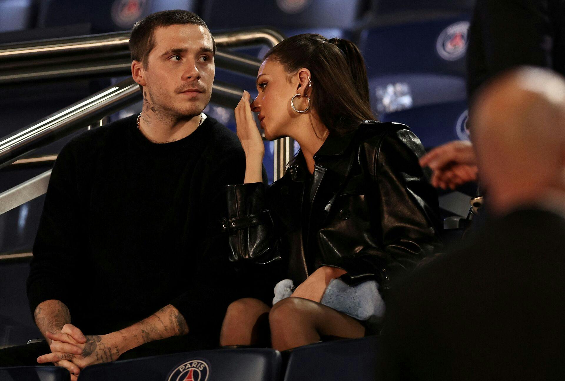 (FILES) Brooklyn Beckham (L) and his wife Nicola Peltz Beckham attend the French L1 football match between Paris Saint-Germain (PSG) and Olympique de Marseille (OM) at The Parc des Princes Stadium in Paris on September 24, 2023. Brooklyn Peltz Beckham, son of the British celebrity couple David and Victoria Beckham, said he did not want to reconcile with his parents after a family rift he described in a lengthy post on social media on January 19, 2026. (Photo by FRANCK FIFE / AFP)