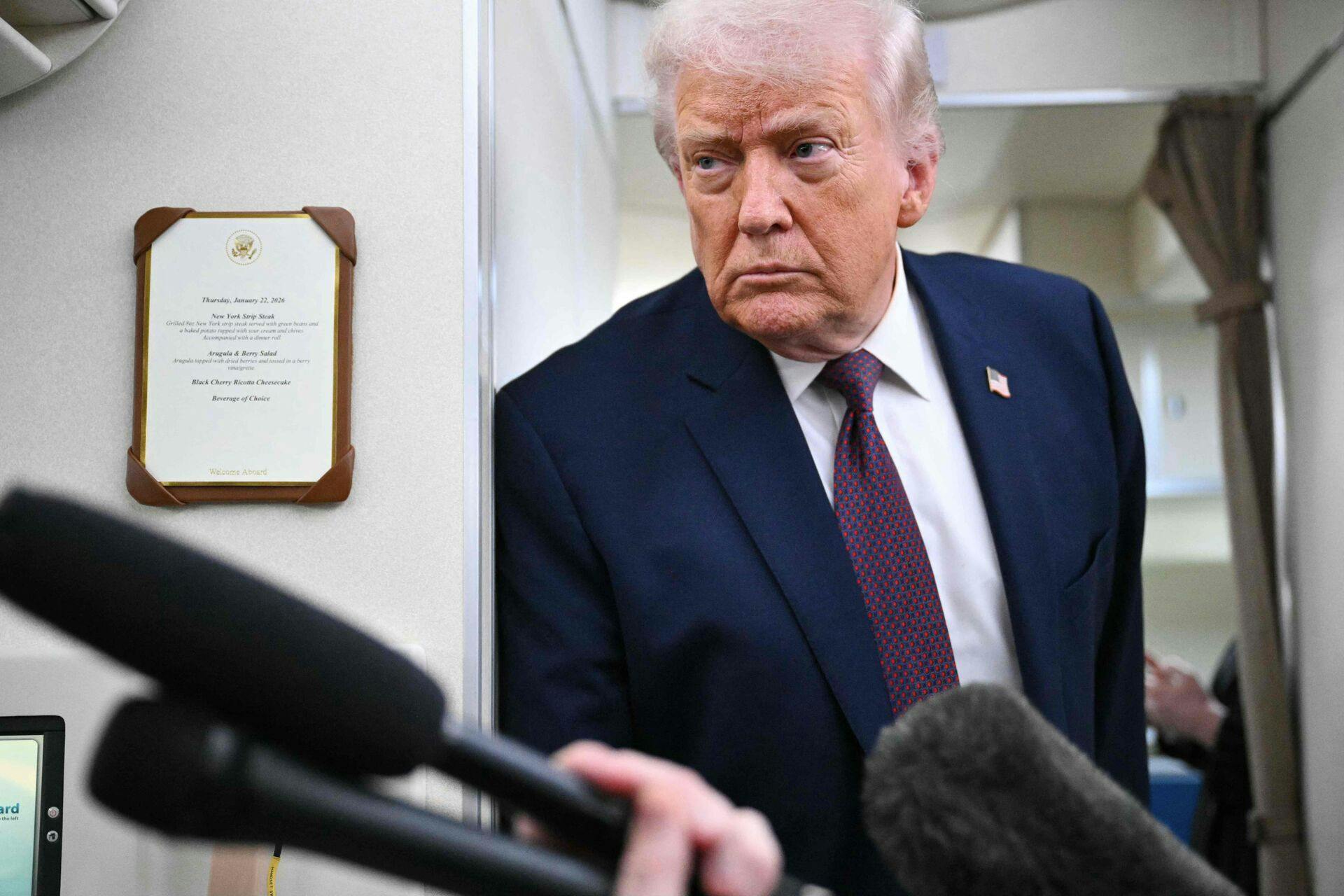 US President Donald Trump speaks to reporters while in flight on Air Force One, traveling from Shannon, Ireland en route Joint Base Andrews in Maryland on January 22, 2026. Trump is returning from Davos, Switzerland after attending the World Economic Forum. (Photo by MANDEL NGAN / AFP)