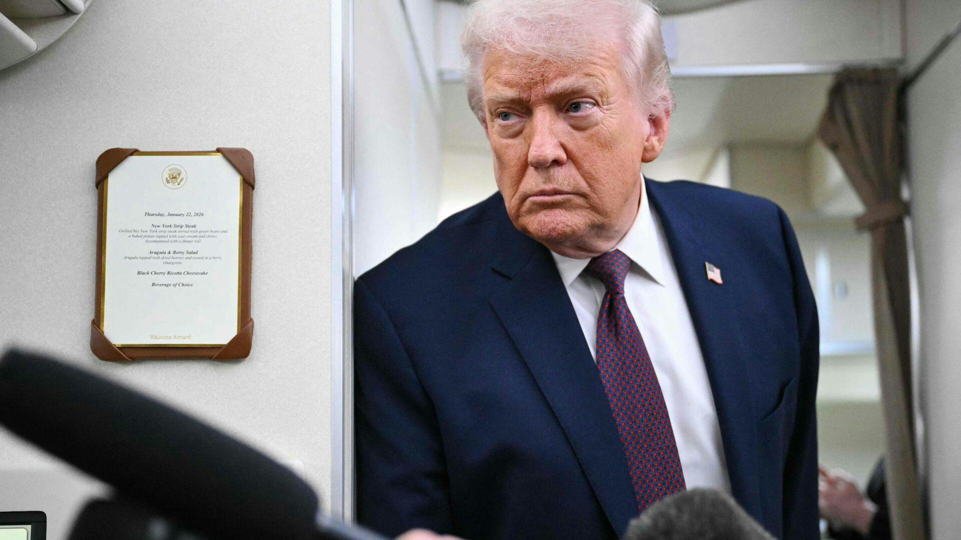 US President Donald Trump speaks to reporters while in flight on Air Force One, traveling from Shannon, Ireland en route Joint Base Andrews in Maryland on January 22, 2026. Trump is returning from Davos, Switzerland after attending the World Economic Forum. (Photo by MANDEL NGAN / AFP)