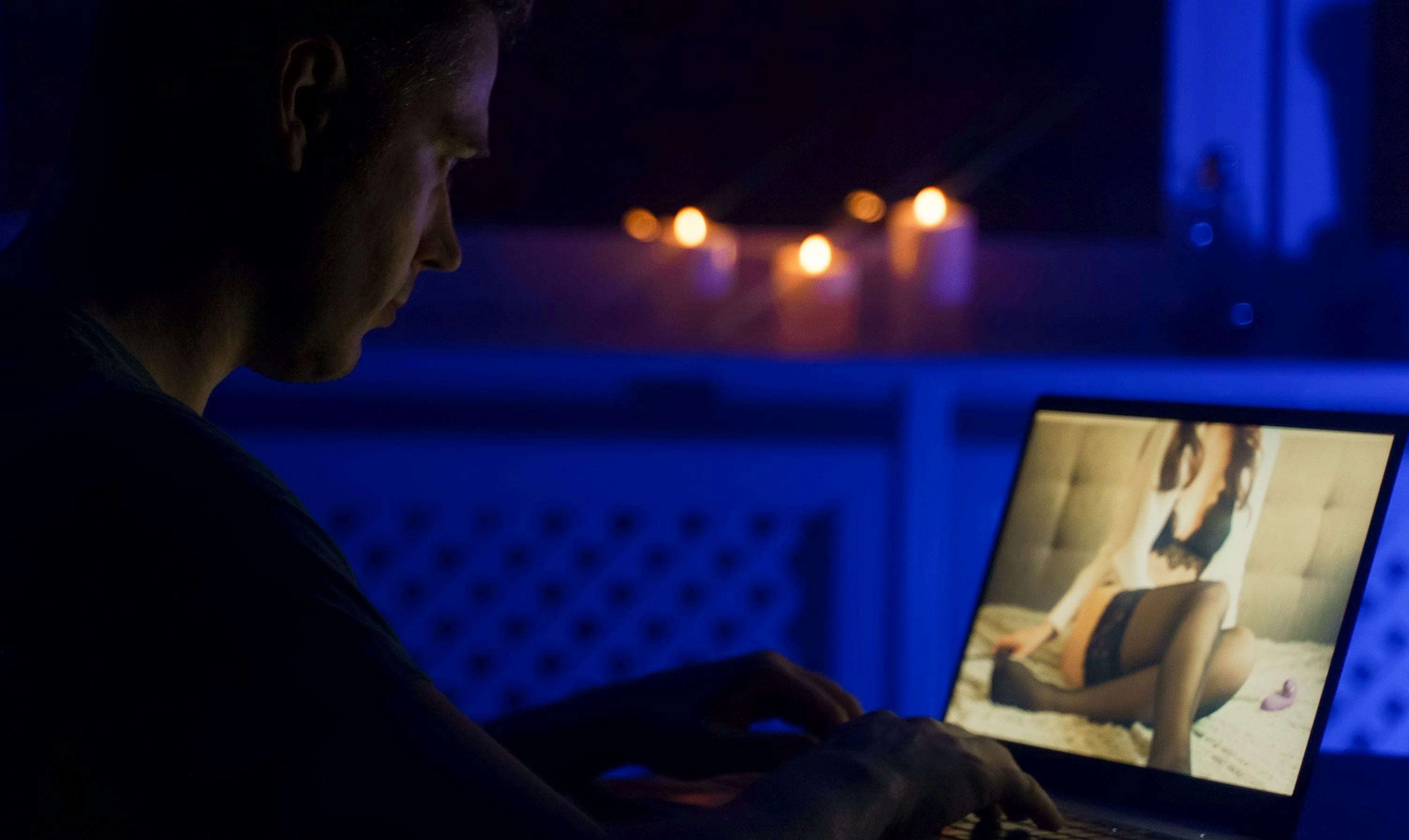 Man chatting with webcam model late at night.