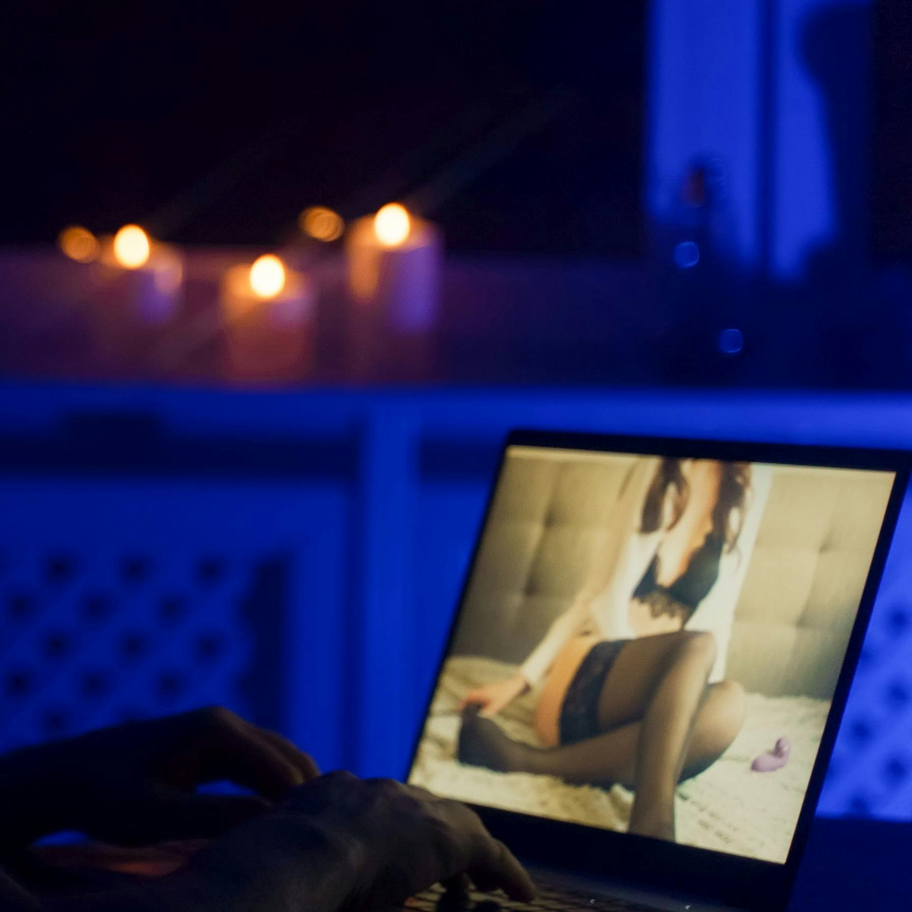 Man chatting with webcam model late at night.