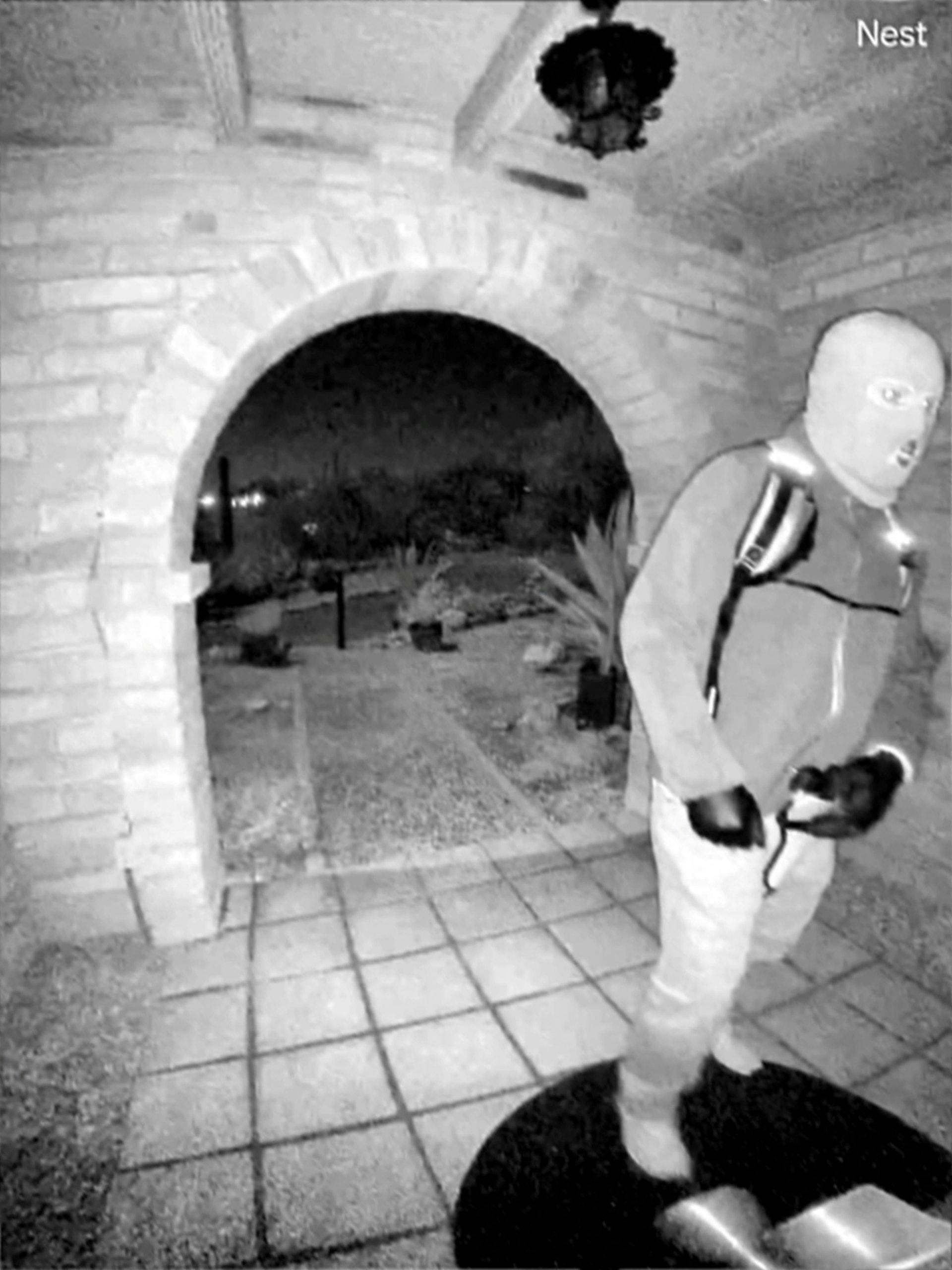 An image captured by a security camera shows what the Federal Bureau of Investigation (FBI) describes as an armed individual appearing to have tampered with the camera at Nancy Guthrie's front door the morning of her disappearance at her home in Tucson, Arizona, U.S., February 1, 2026. Pima County Sheriff's Department/Handout via REUTERS. THIS IMAGE HAS BEEN SUPPLIED BY A THIRD PARTY TPX IMAGES OF THE DAY