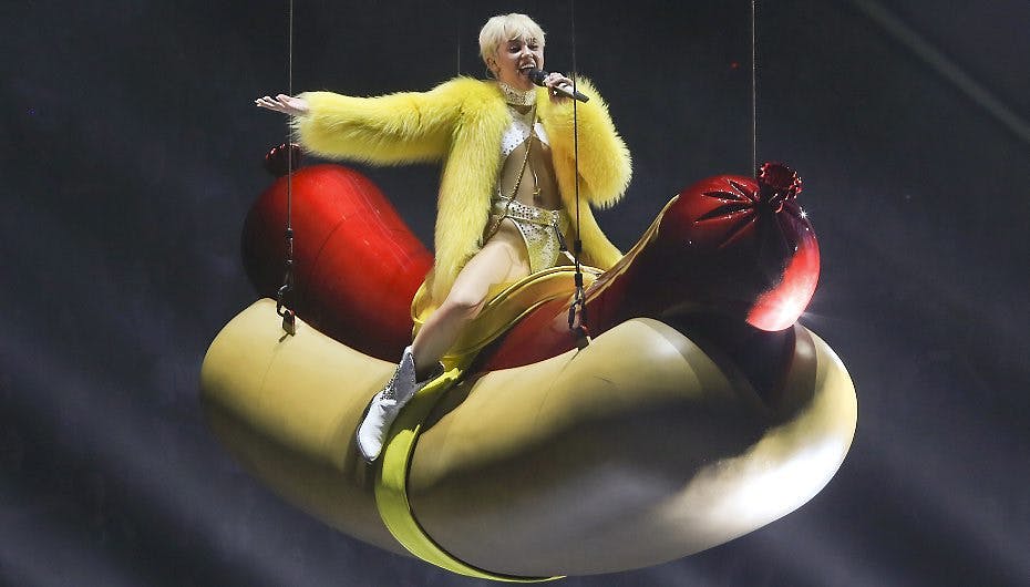 Kæmpepølser og guldbiler - Miley Cyrus gnider sig mod det hele.